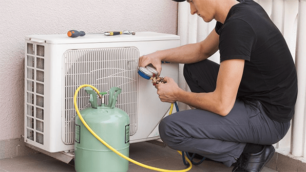 a man is adding refrigerant for air conditioner